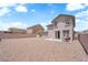 Large backyard with gravel landscaping and a patio area with outdoor seating at 5960 Addy Ln, North Las Vegas, NV 89081