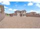 Spacious backyard featuring low-maintenance gravel landscaping and a rear view of the house at 5960 Addy Ln, North Las Vegas, NV 89081