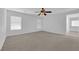 Large bedroom with carpet flooring, ceiling fan, and natural light from the windows at 5960 Addy Ln, North Las Vegas, NV 89081