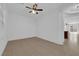 Bedroom with neutral tile flooring, a ceiling fan, and a view into a separate room at 5960 Addy Ln, North Las Vegas, NV 89081