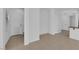 Hallway featuring neutral tile flooring, white walls, and access to the front door and other rooms at 5960 Addy Ln, North Las Vegas, NV 89081