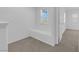 Bright hallway with neutral carpet, white walls, and a window seat at 5960 Addy Ln, North Las Vegas, NV 89081