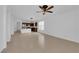 Spacious living room featuring tile flooring, a ceiling fan, and an open layout leading to the kitchen area at 5960 Addy Ln, North Las Vegas, NV 89081