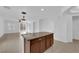 Open-concept kitchen featuring stainless steel appliances, a large island, and bright living space at 5960 Addy Ln, North Las Vegas, NV 89081