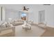 Bright living room with neutral tones, contemporary furnishings, and a sliding glass door bringing in natural light at 5960 Addy Ln, North Las Vegas, NV 89081