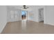 An empty living room featuring a ceiling fan and a sliding glass door bringing in natural light at 5960 Addy Ln, North Las Vegas, NV 89081