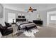 This staged bedroom features plush rugs, a ceiling fan, and a lovely sitting area at 5960 Addy Ln, North Las Vegas, NV 89081