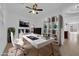 Home office setup with a white desk, shelving, and modern decor, providing a comfortable workspace at 5960 Addy Ln, North Las Vegas, NV 89081