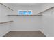 Spacious walk-in closet with built-in shelving and a window for natural light at 5960 Addy Ln, North Las Vegas, NV 89081
