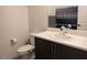 Modern bathroom with dark vanity, white countertop, and updated fixtures at 6830 Truffle Gray St, Las Vegas, NV 89148