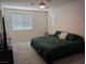 Inviting bedroom featuring a ceiling fan and a large window for natural light at 6830 Truffle Gray St, Las Vegas, NV 89148