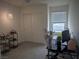 Bright bedroom with a large window, closet, and modern light fixture at 6830 Truffle Gray St, Las Vegas, NV 89148