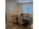 Dining area with wood-look floors and a wooden dining table with four chairs at 6830 Truffle Gray St, Las Vegas, NV 89148