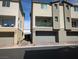 Modern townhome exterior features a neutral color scheme and attached garages at 6830 Truffle Gray St, Las Vegas, NV 89148