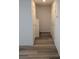 Hallway with gray wood flooring and white walls leading to the stairs at 6830 Truffle Gray St, Las Vegas, NV 89148