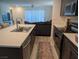 The modern kitchen is complemented by a kitchen island and stainless steel appliances at 6830 Truffle Gray St, Las Vegas, NV 89148