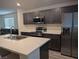 Modern kitchen features stainless steel appliances and gray cabinetry offering sleek design and functionality at 6830 Truffle Gray St, Las Vegas, NV 89148