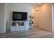 Modern living area with hardwood floors, a large television, and minimalist decor at 6830 Truffle Gray St, Las Vegas, NV 89148