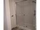 Enclosed shower with glass doors and updated fixtures, adjacent to a white door at 6830 Truffle Gray St, Las Vegas, NV 89148