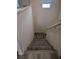 Carpeted stairs with a white railing leading to the lower level with wood-look flooring at 6830 Truffle Gray St, Las Vegas, NV 89148