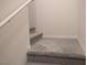 Carpeted stairway landing with white trim and neutral walls at 6830 Truffle Gray St, Las Vegas, NV 89148