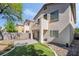 A well-maintained backyard features stone, grass, patio, and an upper story balcony that enhances outdoor living and curb appeal at 7047 Sombra Way, Las Vegas, NV 89113