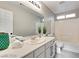 Bright bathroom featuring white cabinets and a tiled shower-tub combination at 7047 Sombra Way, Las Vegas, NV 89113