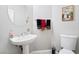 Bathroom with toilet, sink, chrome faucet, and decorative towels and artwork at 7047 Sombra Way, Las Vegas, NV 89113