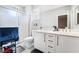 Bathroom featuring double sinks, modern fixtures, white cabinets, shower, and gray walls at 7047 Sombra Way, Las Vegas, NV 89113