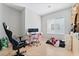 Bedroom features hardwood floors, a window, and a desk with dual monitors at 7047 Sombra Way, Las Vegas, NV 89113