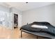 Bedroom featuring hardwood floors, closet, and a black bed frame with bedding at 7047 Sombra Way, Las Vegas, NV 89113