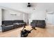 Spacious bonus room featuring a cozy gray sofa and exercise equipment at 7047 Sombra Way, Las Vegas, NV 89113