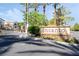 The community entrance sign features lush landscaping, rock features, and decorative accents that welcome residents and visitors at 7047 Sombra Way, Las Vegas, NV 89113