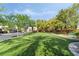 A large grassy area with shade trees and walking path provides neighborhood residents a relaxing space to enjoy the outdoors at 7047 Sombra Way, Las Vegas, NV 89113