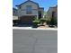 Two-story home featuring a two-car garage and manicured landscaping at 7047 Sombra Way, Las Vegas, NV 89113