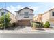 Charming two-story home with a well-maintained front yard and attached two-car garage at 7047 Sombra Way, Las Vegas, NV 89113