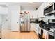 Contemporary kitchen with stainless appliances, stylish cabinets, and bright lighting at 7047 Sombra Way, Las Vegas, NV 89113