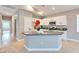 This kitchen features an island with gray countertops and white cabinets at 7047 Sombra Way, Las Vegas, NV 89113