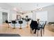 Open kitchen featuring a breakfast bar, stainless appliances, and contemporary lighting fixtures at 7047 Sombra Way, Las Vegas, NV 89113
