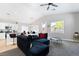 This living room features gray walls, modern lighting, breakfast bar, and a view of the kitchen at 7047 Sombra Way, Las Vegas, NV 89113