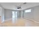 Spacious living room with wood floors, ceiling fan, and sliding glass door at 7047 Sombra Way, Las Vegas, NV 89113