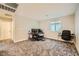 A bedroom with neutral walls and carpet flooring set up as a home office at 707 Cottonwood Hill Pl, Henderson, NV 89011