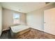 A bright bedroom features neutral walls, a window, and plush carpeting, with a simple mattress on the floor at 707 Cottonwood Hill Pl, Henderson, NV 89011