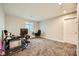 Spacious bedroom with neutral walls, carpet flooring and a window, currently staged as a home office at 707 Cottonwood Hill Pl, Henderson, NV 89011