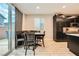 Eat-in kitchen showcases dark cabinetry, bench seating and a sliding glass door to the outside at 707 Cottonwood Hill Pl, Henderson, NV 89011