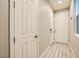 Bright hallway featuring white doors, stylish flooring, and a clean, modern aesthetic at 707 Cottonwood Hill Pl, Henderson, NV 89011
