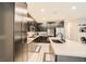 Well-equipped kitchen with modern appliances, spacious countertops, and ample storage with seamless transition to other rooms at 707 Cottonwood Hill Pl, Henderson, NV 89011