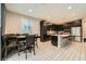 A modern eat-in kitchen offers dark cabinetry, stainless steel appliances, and an island with bar seating at 707 Cottonwood Hill Pl, Henderson, NV 89011