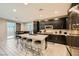 Modern kitchen with island, bar stool seating, stainless steel appliances and ample cabinet space at 707 Cottonwood Hill Pl, Henderson, NV 89011