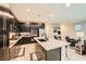 Open kitchen showcasing a central island with bar stools, stainless steel appliances, and access to the living area at 707 Cottonwood Hill Pl, Henderson, NV 89011